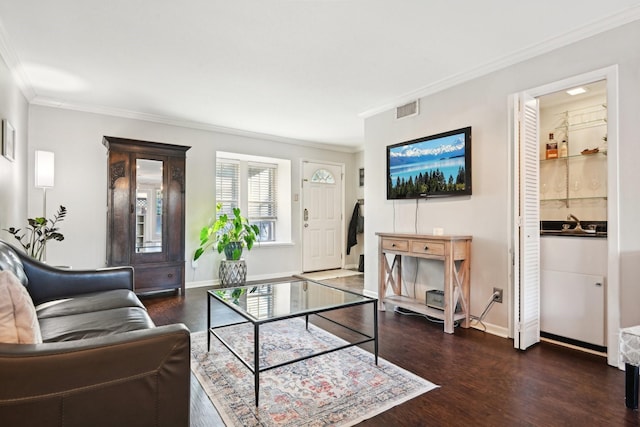 living room featuring ornamental molding and dark wood-type flooring