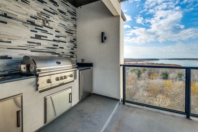 view of patio / terrace with area for grilling and a water view