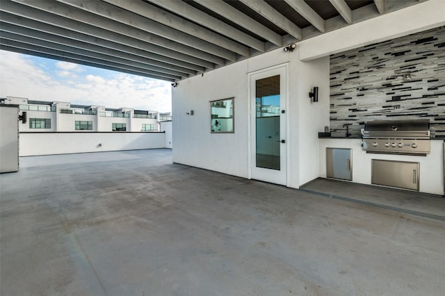 view of patio with an outdoor kitchen and a grill