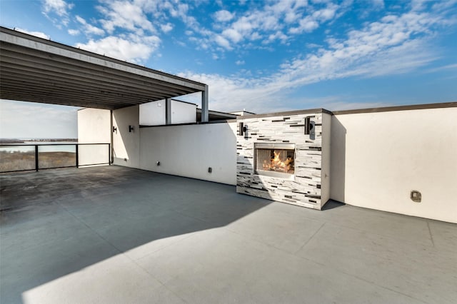 view of patio with a fireplace