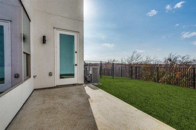 view of yard with central AC unit and a patio area