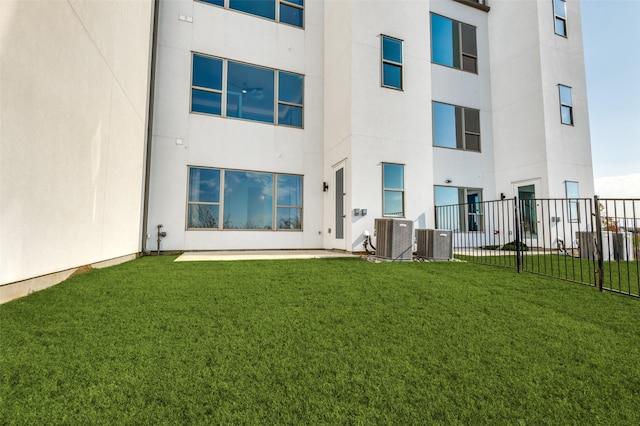 back of house with a yard and central AC unit