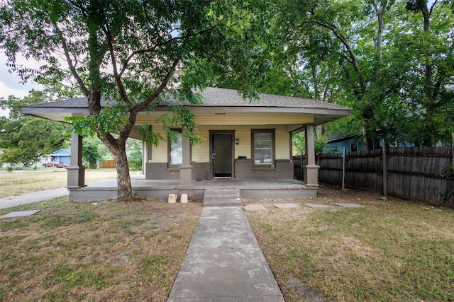 view of front of house featuring a front lawn and covered porch