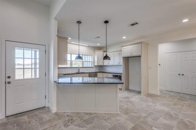 kitchen with white cabinetry, sink, dishwasher, kitchen peninsula, and pendant lighting