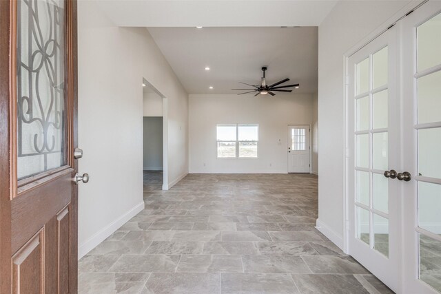 entrance foyer featuring ceiling fan and french doors