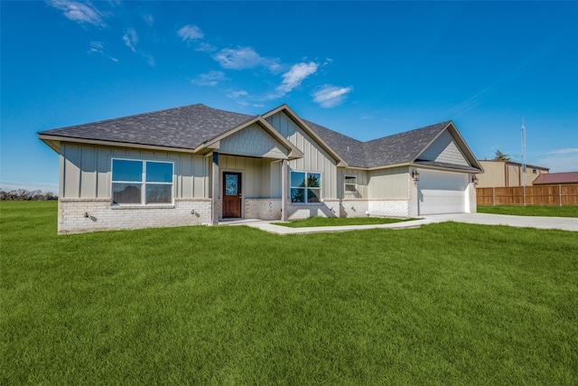 view of front facade with a front yard and a garage