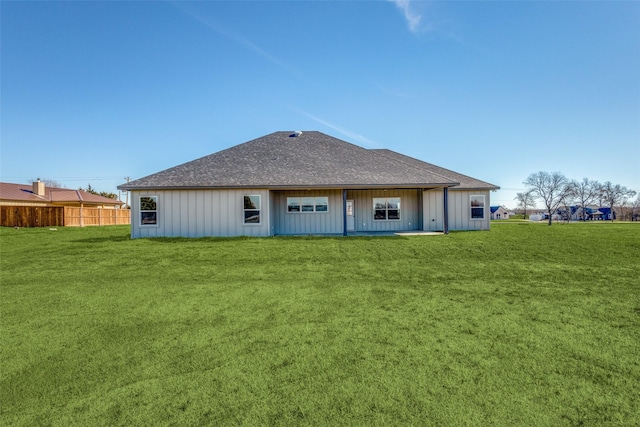 rear view of house with a yard