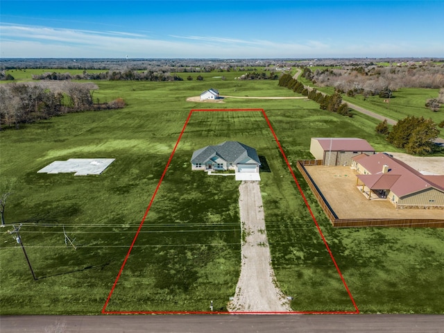 birds eye view of property with a rural view