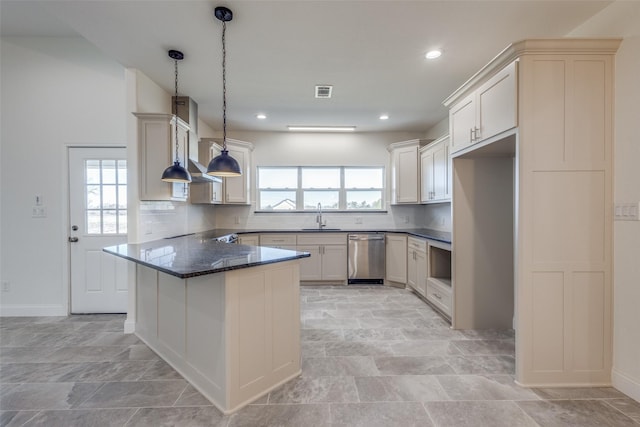 kitchen featuring dishwasher, backsplash, dark stone counters, hanging light fixtures, and wall chimney exhaust hood