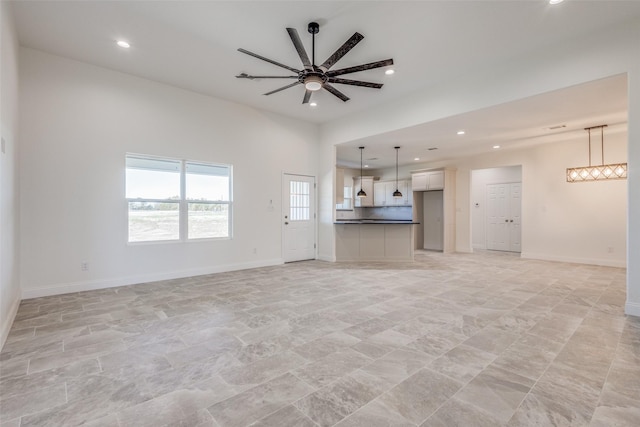 unfurnished living room with ceiling fan