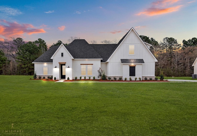 modern farmhouse style home featuring central AC unit and a lawn