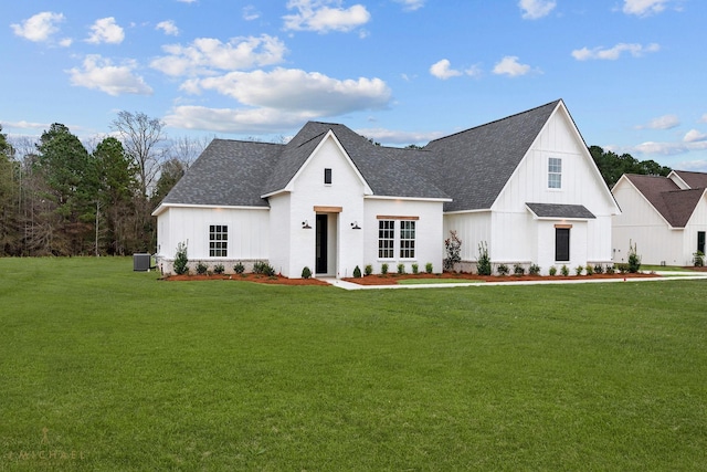 modern farmhouse with cooling unit and a front yard