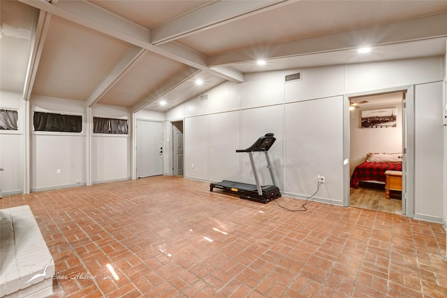 workout room featuring lofted ceiling