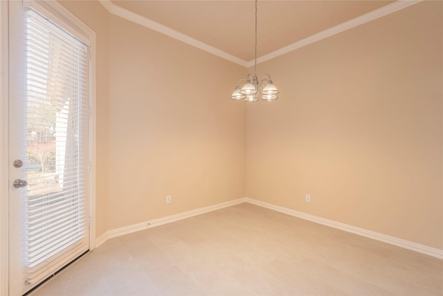 empty room featuring a chandelier, ornamental molding, and baseboards