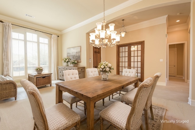 dining space with french doors, visible vents, an inviting chandelier, ornamental molding, and baseboards