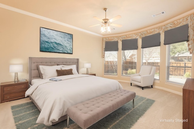 bedroom with carpet, visible vents, and crown molding