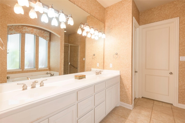 bathroom with a stall shower, tile patterned flooring, a sink, and wallpapered walls