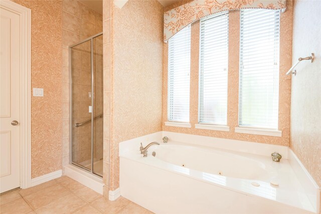 bathroom featuring a stall shower, tile patterned flooring, a tub with jets, and wallpapered walls