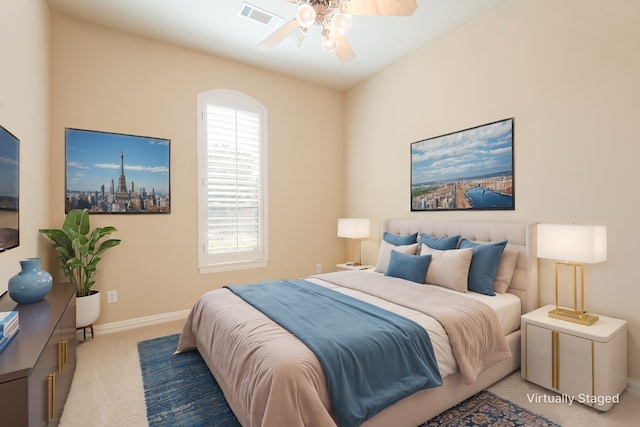 carpeted bedroom featuring a ceiling fan, visible vents, and baseboards