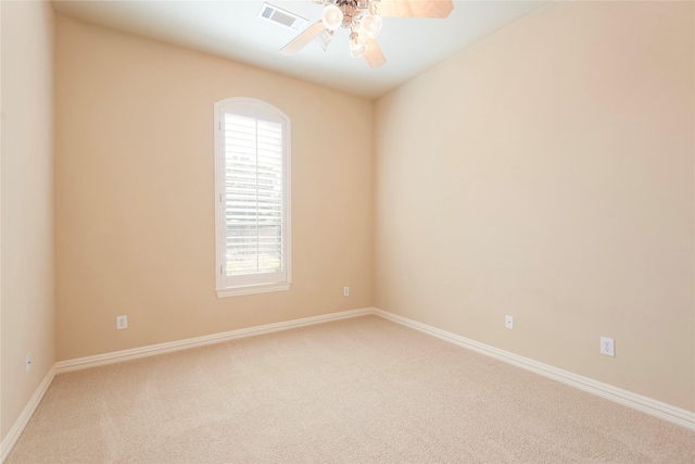 spare room with carpet, visible vents, ceiling fan, and baseboards