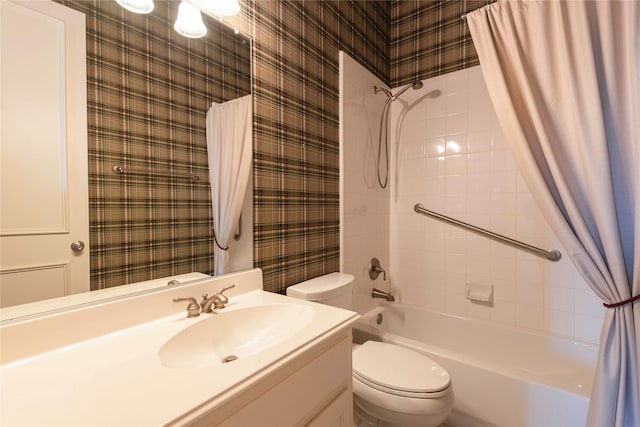 bathroom featuring shower / bath combo, vanity, toilet, and wallpapered walls