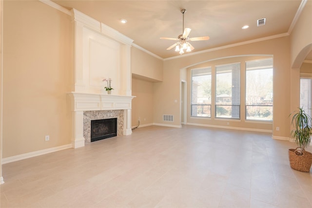 unfurnished living room featuring baseboards, a fireplace, visible vents, and crown molding