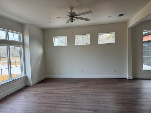 unfurnished room with ceiling fan and dark wood-type flooring