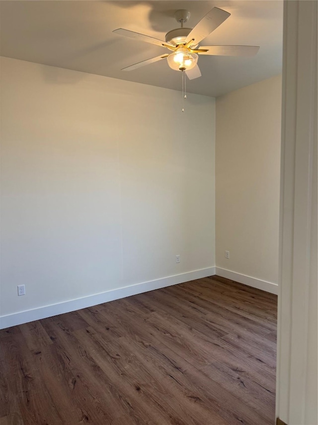 empty room with ceiling fan, baseboards, and dark wood-style flooring