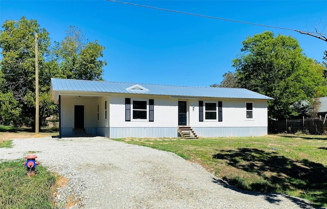 view of front of property with a carport and a front yard