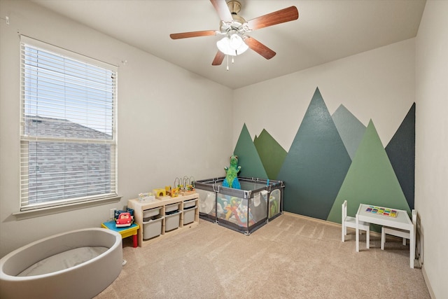 playroom with ceiling fan and light colored carpet