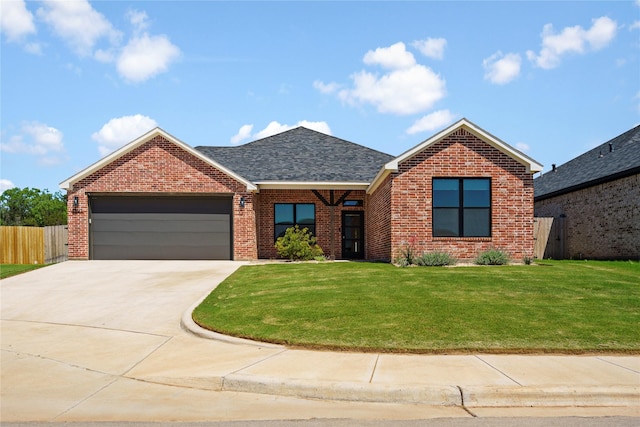 view of front of house with a front lawn and a garage