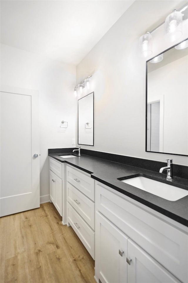 bathroom featuring hardwood / wood-style flooring and vanity