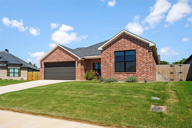 view of front of property with a front yard and a garage