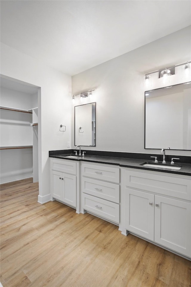 bathroom with wood-type flooring and vanity