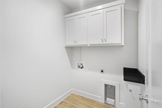 washroom with cabinets, hookup for an electric dryer, hookup for a washing machine, and light wood-type flooring