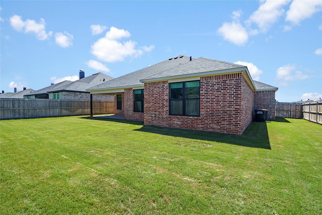 back of house featuring a patio area, a yard, and central AC