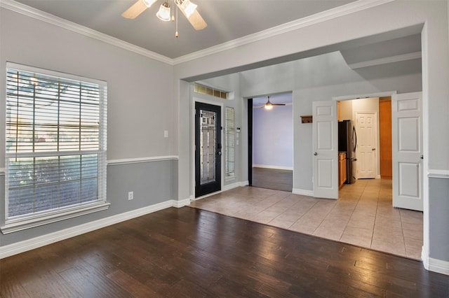 foyer featuring ceiling fan, ornamental molding, and light wood-type flooring