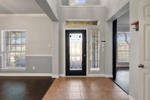 foyer featuring hardwood / wood-style flooring and ornamental molding