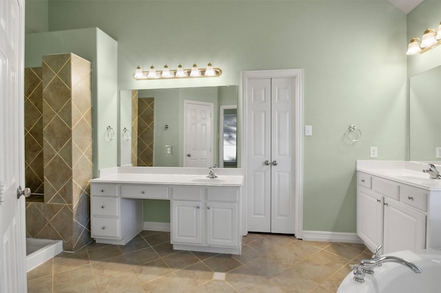 bathroom with vanity, tile patterned flooring, and a shower