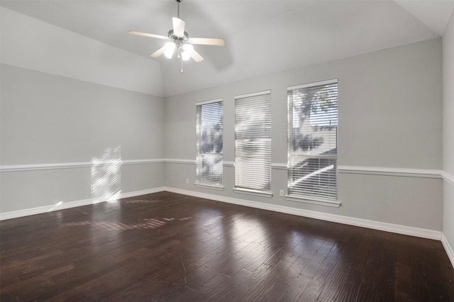 spare room with ceiling fan, wood-type flooring, and vaulted ceiling