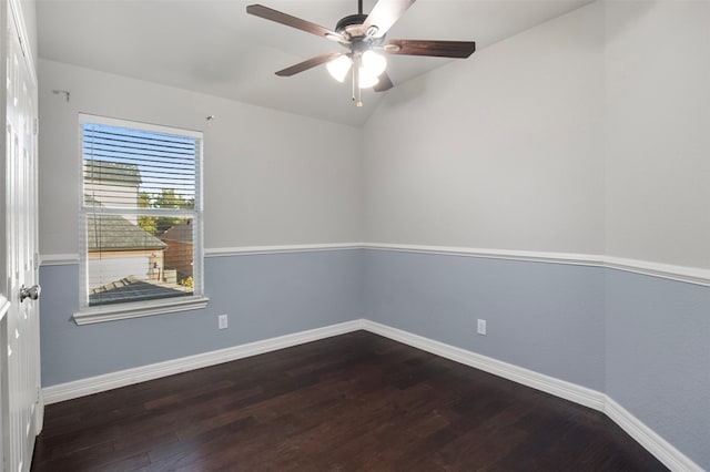 spare room with vaulted ceiling, dark wood-type flooring, and ceiling fan