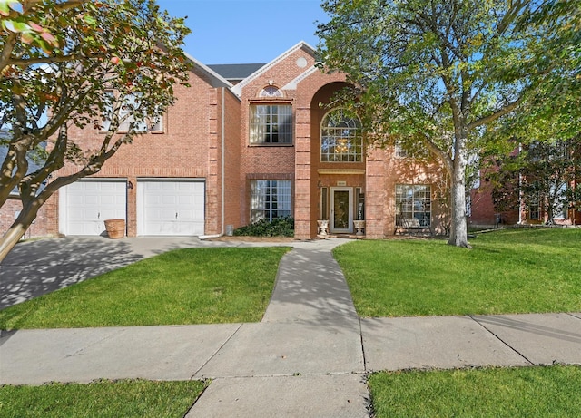 view of front of home with a front yard, concrete driveway, brick siding, and an attached garage