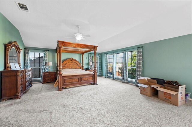 bedroom featuring lofted ceiling, light carpet, and ceiling fan