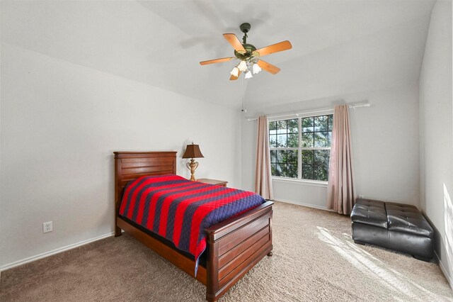 bedroom featuring ceiling fan, lofted ceiling, and carpet