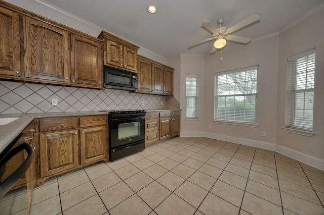 kitchen with tasteful backsplash, crown molding, black appliances, and light tile patterned flooring