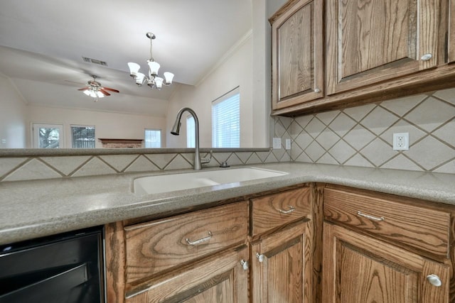 kitchen with wine cooler, lofted ceiling, sink, ornamental molding, and decorative backsplash