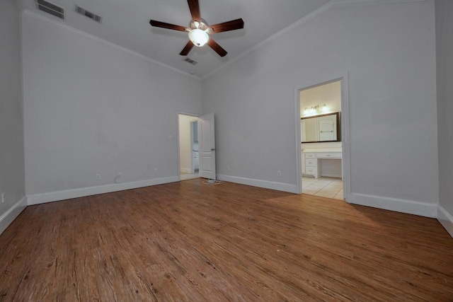 unfurnished room with vaulted ceiling, ceiling fan, ornamental molding, and light hardwood / wood-style floors