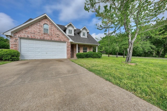 view of front of property featuring a garage and a front lawn