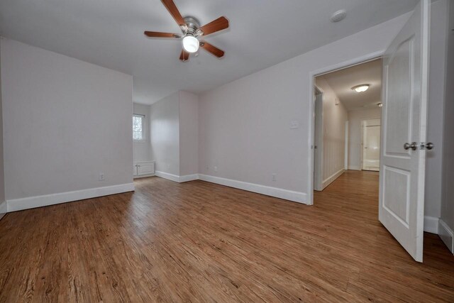 empty room featuring ceiling fan and light hardwood / wood-style flooring