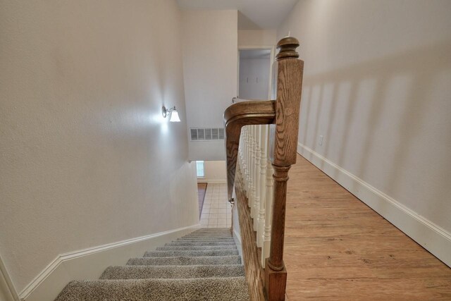 staircase with wood-type flooring